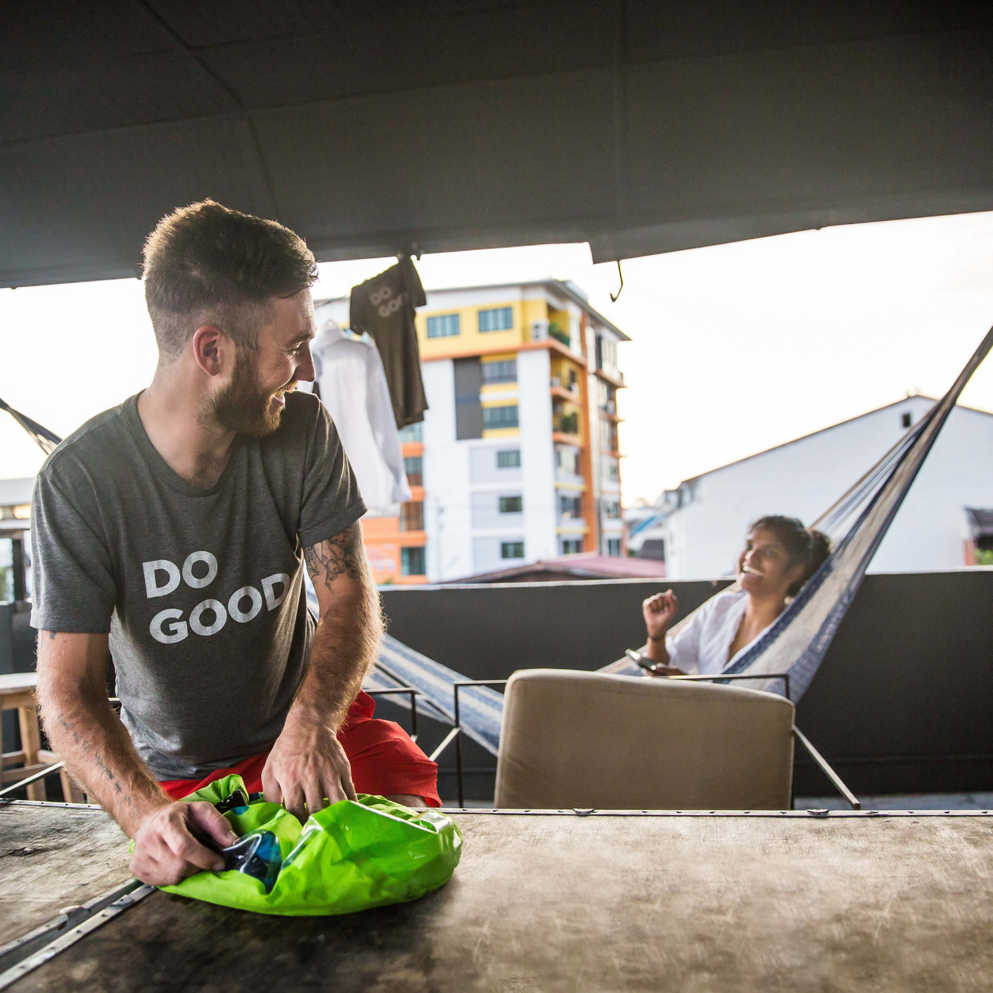 Man using portable washing machine Scrubba in backpackers